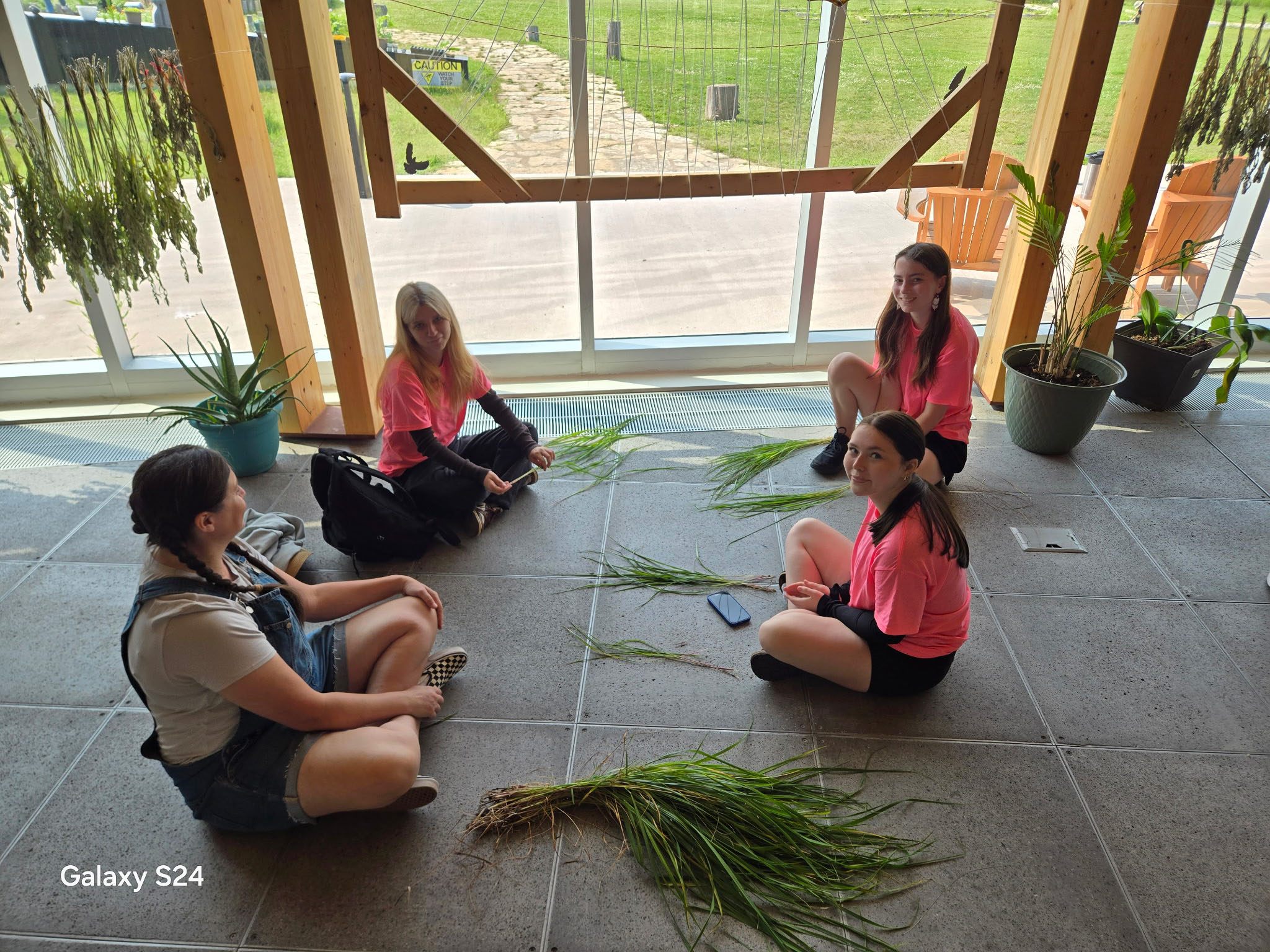 Group of students with grass indoors at SKG